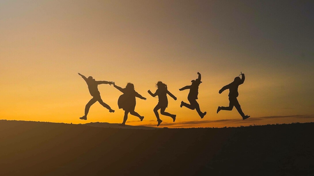 Five people jumping together