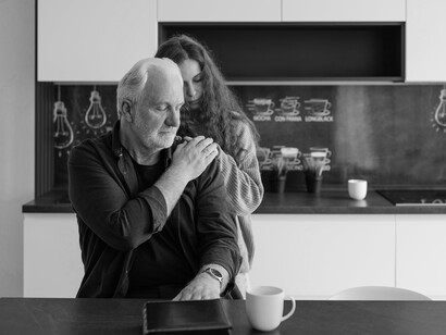 An elderly man and a woman expressing grief and sorrow
