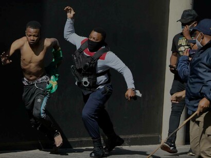 A South African police officer attempting to apprehend a runaway suspect that was involved in the protests against the government
