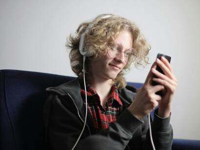 Jovem assiste à vídeos em plataforma de streaming