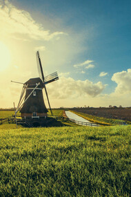 Vintage black windmill at sunset in Uithuizermeeden, Groningen, Netherlands 