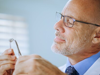 A man looking at a sample. Nanosensors can be used to diagnose illness 