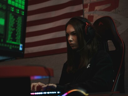 A woman sat a desk using a computer