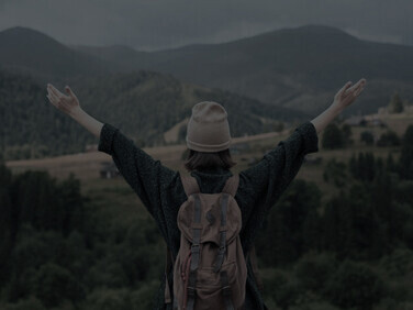 In the midst of her solo expedition, a woman finds pure delight in the breathtaking rural vistas, embracing the serenity of her solo travel escapade