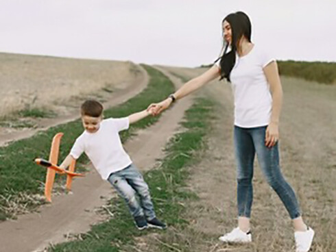 A mother and her little son playing with a toy plane, showcasing self-expression, autonomy, and the parent-child relationship