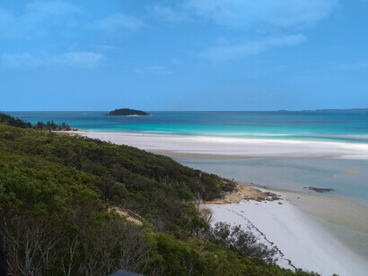 La arena blanca, tan brillante que parece nieve, el mar color turquesa y un cielo azul intenso que, al mirarlo con el sol, parece cegarte. Vista norte de la playa de Whitehaven, isla Hamilton, Queensland, Australia