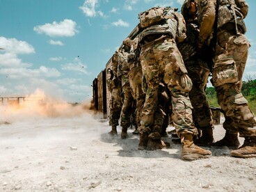 Soldiers operating in an active combat zone, reflecting the growing reliance on military power in international affairs