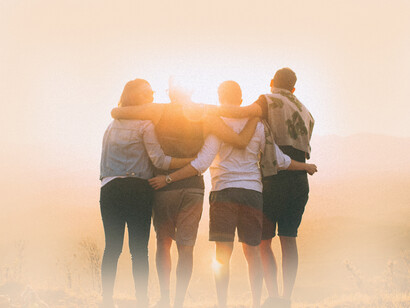 Four friends accepting of one another stare at the sunset