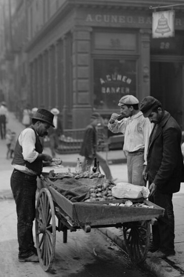 A clam seller among street peddlers in Mulberry Bend, New York City, US