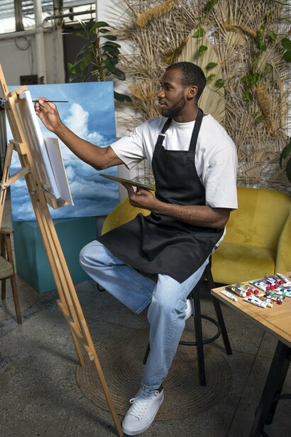 A painter immersed in his craft within a modern studio, symbolising the spirit of African art across changing generations