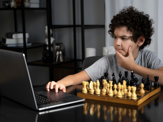 Pensive, a young chess player competes against a chess software