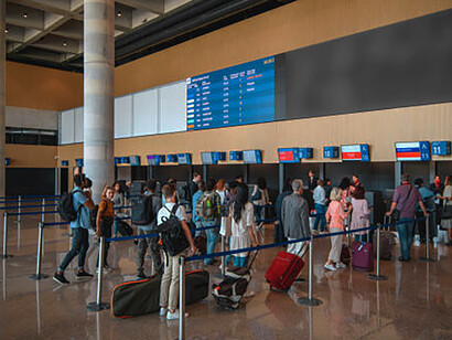 Travelers waiting at the airport for check-in, preparing to pass through border security, visa control, and customs checks
