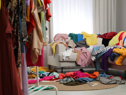 There is a mess of clothes all over the room