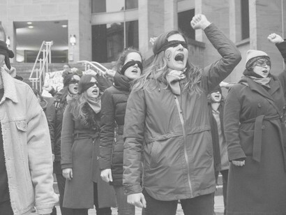 Women blindfolded and protesting on the street for their rights
