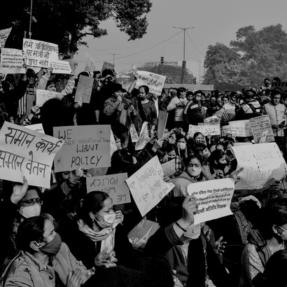 A black-and-white photo captures women protesting with banners, highlighting activism, advocacy, and social awareness