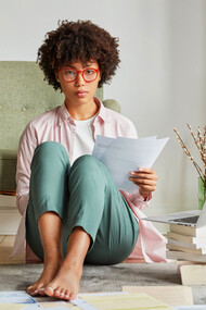 Embracing the flexibility of hybrid work, this woman enjoys the freedom to balance professional tasks with personal moments from the comfort of her home