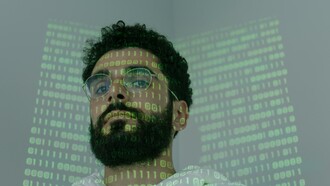 A man with computer code shone over his face 