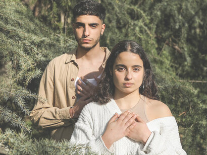 A couple nestled amidst lush greenery