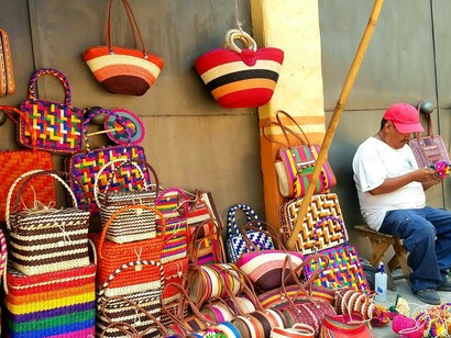 A vendor in Tepoztlan, Mexico selling handmade bags and purses