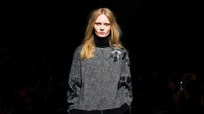 Intense and focused, this model's stare mirrors the fashion industry's urgent shift towards climate resilience and sustainable practices in 2024