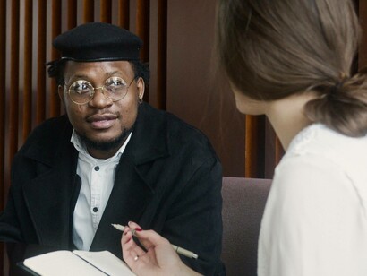 The male candidate listening to the female HR representative's question