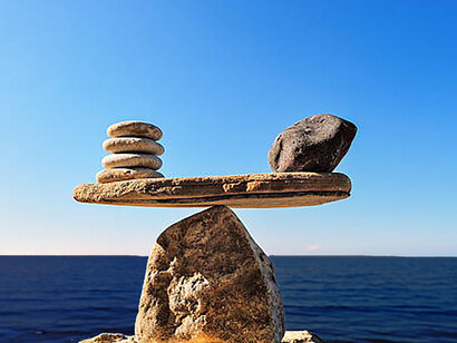 Perfect equilibrium displayed by the stones at the water's edge