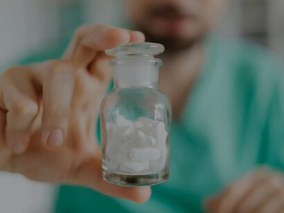 In the doctor's hand rests a comprehensive collection of medicines