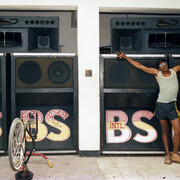 Beth Lesser, Papa Screw, selector for the Black scorpio sound system, in front of the speaker boxes in the Scorpio headquarters, Drewsland, Kingston, Jamaica (detail), 1985. Courtesy of MCA Chicago