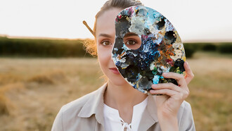 A creative young woman holding a painting palette, inspired by the connection between art and dreams, surrounded by surreal imagery
