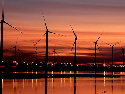 Sunset over wind farms, reflecting both the beauty and complexity of sustainable power