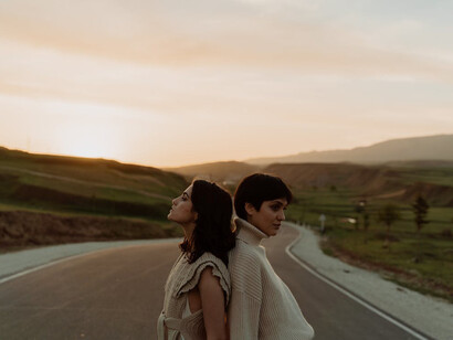 With their backs turned to the world, these friends personify the patience and determination needed to navigate the complexities of timing and age, finding solace in trust and inner strength