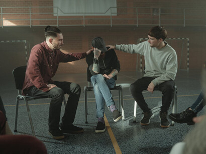 In a group therapy session, men discuss the systemic power dynamics that perpetuate sexual exploitation and abuse, questioning how societal norms have shaped their perceptions of gender and privilege