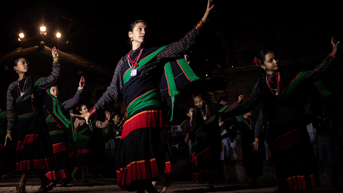 Members of the Newar community perform a traditional dance at Patan Durbar Square during the Lalit Carnival, celebrating World Tourism Day