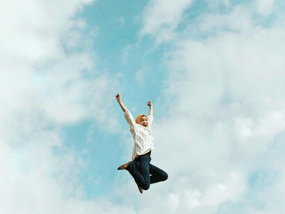 Woman jumping in the air in celebration