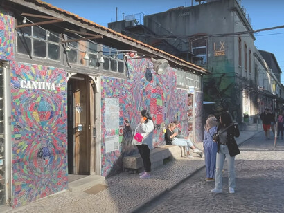 LX Factory in Lisbon, a prime example of adaptive reuse, where old industrial buildings have been repurposed into trendy offices, studios, shops, and restaurants, fostering a dynamic community atmosphere