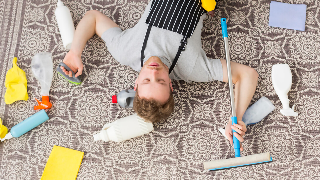 A tired man from cleaning the carpet, seen from above