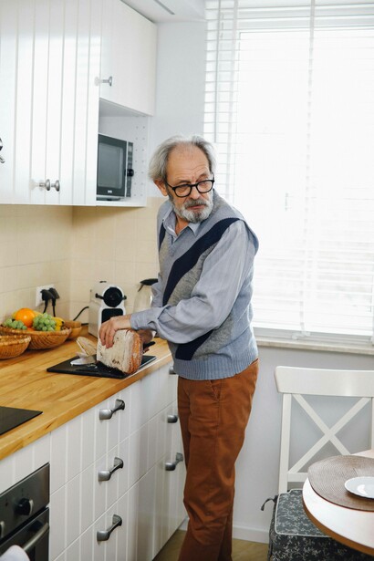 Man turns back to look at his wife as he prepares breakfast