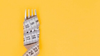 Measuring tape wrapped around a fork, showing the importance of addressing the causes of obesity