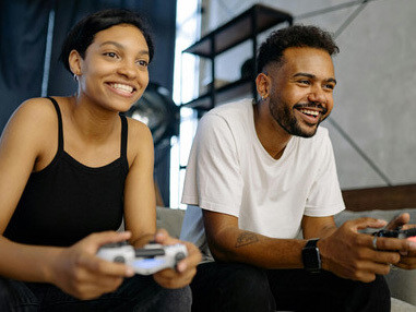 Two partners bonding through their shared passion for gaming on a console
