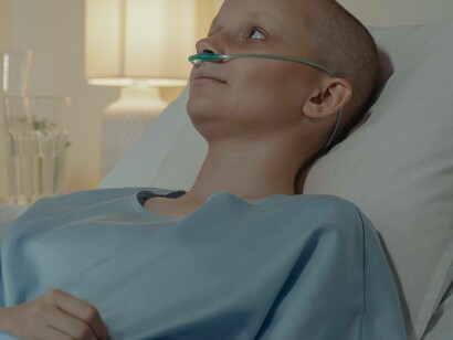 Patient lying down with breathing tube