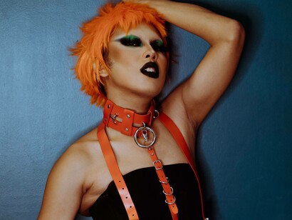 A transgender woman posing for the camera in a provocative outfit