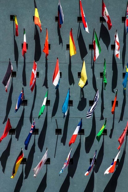 Flags of diverse countries; imagine standing before a mirror that doesn't just show your reflection, but the faces of billions