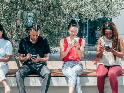 A group of friends using their smartphones