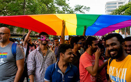 Members and supporters of the lesbian, gay, bisexual, and transgender community, some wearing masks, participate in a Pride March rally in Bangalore, India, on Sunday, November 22, 2015