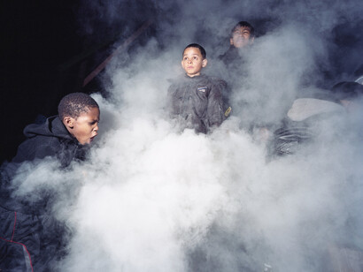 Mark Neville, Kids at Somerford Grove Adventure Playground, Tottenham, put out the barbeque fire,
2011, C-type print, Paper 127 x 154 cm, Image 108 x 135 cm, Edition of 5, © Mark Neville, courtesy of the artist and Alan Cristea Gallery