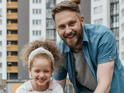 A father and daughter, both beaming with happiness after creating memories together that are far more valuable than the relentless pursuit of work and material success