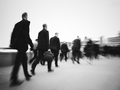 A group of professionals rushing through the city, capturing the fast-paced rhythm of modern life