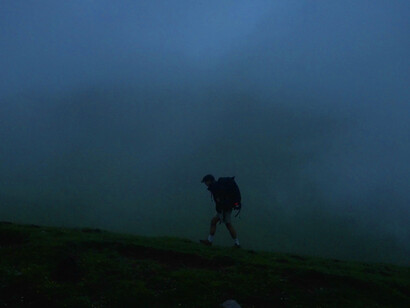 The fog enveloping the mountains mirrors the obscured choices we face, reminding us that adapting to harsh environments can lead to the loss of our true selves