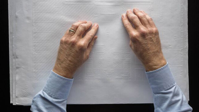 Chris Downey reading a braille and printed architectural plan, Don Fogg, 2017. © Don Fogg