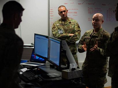 U.S. Air Force Tech. Sgt. Daniel Bowser, 1st Combat Communications Squadron mission defense team section chief assigned to Ramstein Air Base, Germany, discusses the integrity of data with other participants of Tacet Venari during the exercise at Ramstein Air Base, May 19, 2022